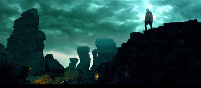 a man standing on top of a rocky cliff