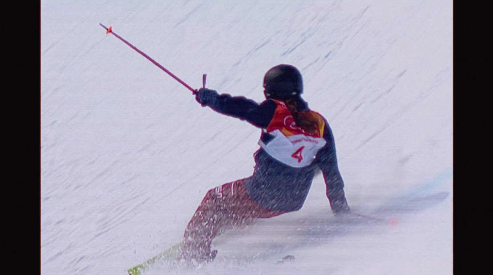 a man riding skis down a snow covered slope