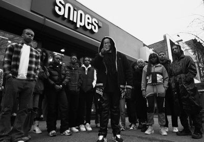 a group of people standing in front of a store