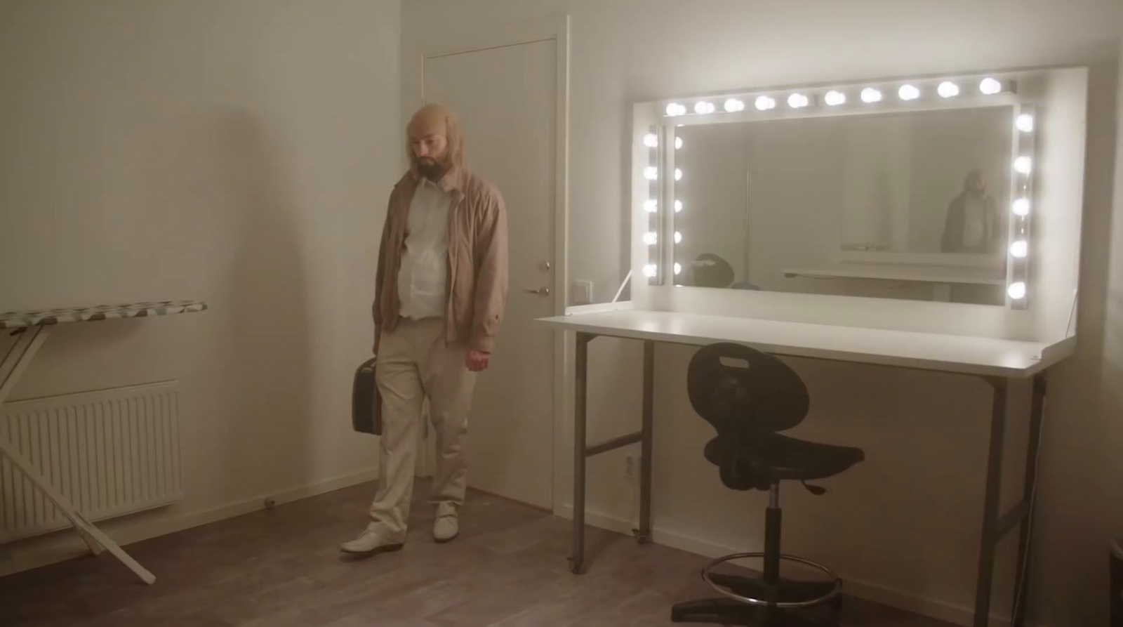 a man standing in front of a mirror in a room