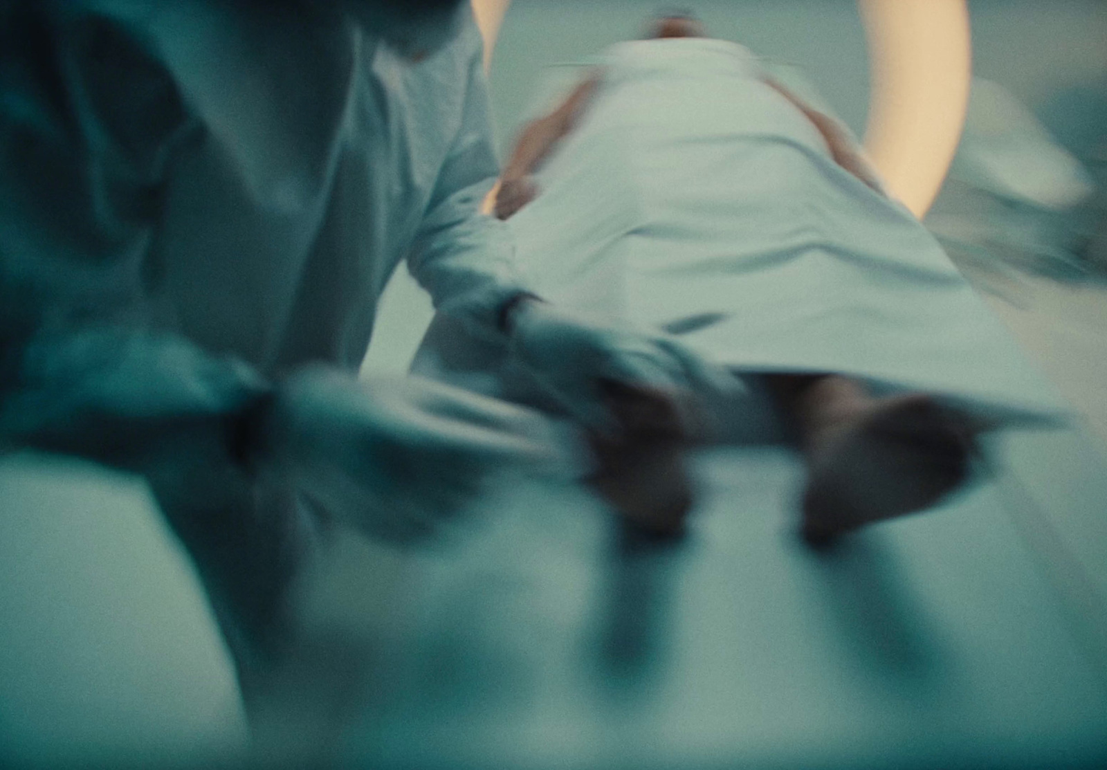 a person laying in a hospital bed in a room