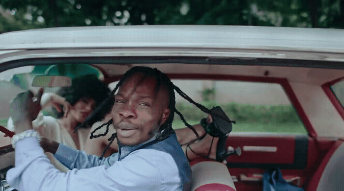 a man with dreadlocks sitting in a car