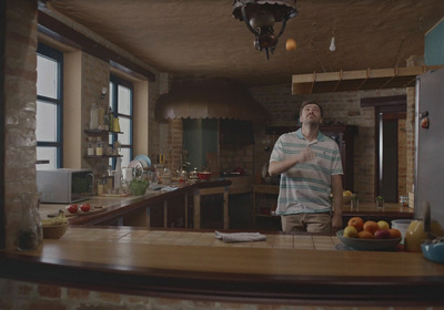 a man standing in a kitchen next to a counter