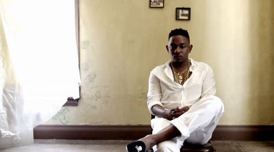 a man sitting on a stool in a room