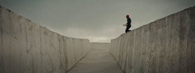 a person standing on top of a cement wall