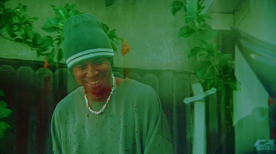 a woman wearing a green hat and a green shirt