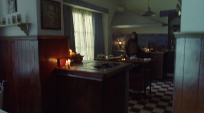 a woman standing in a kitchen next to a counter