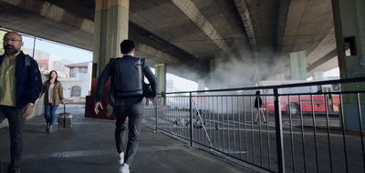 a group of people walking under a bridge