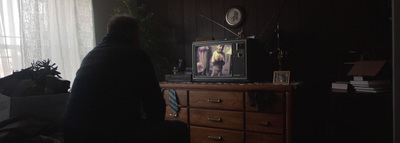 a person standing in front of a tv in a dark room