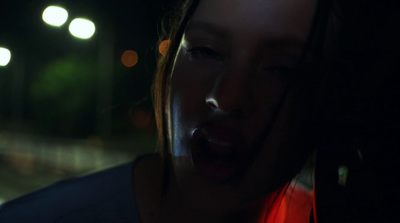 a woman with her mouth open in the dark