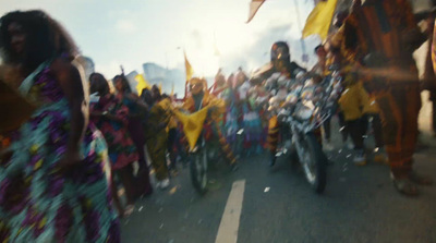 a group of people riding motorcycles down a street