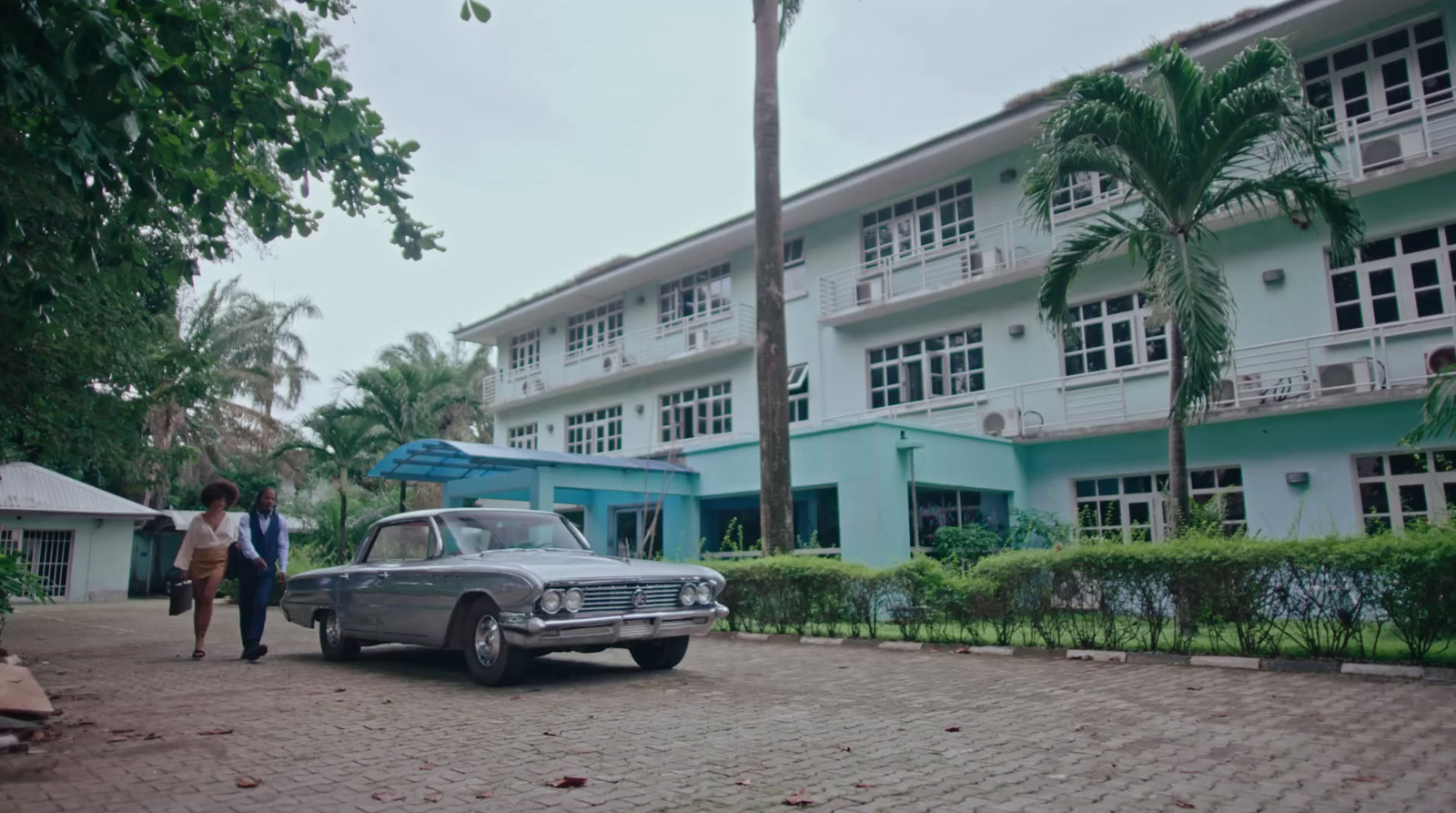 a car parked in front of a multi - story building