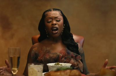 a woman sitting at a table with a plate of food