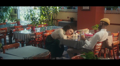 a man and woman sitting at a table in a restaurant