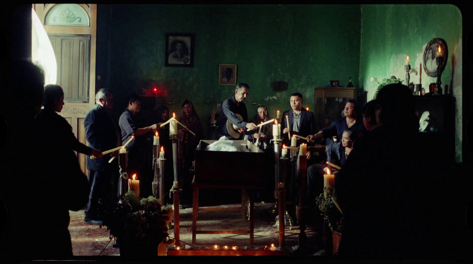 a group of people standing around a table with candles