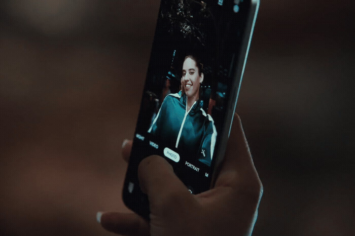 a person holding a cell phone in their hand