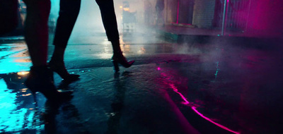 a woman walking down a street in the rain