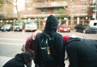 a group of people standing on the side of a road