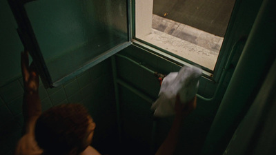 a person standing in a bathroom next to a window