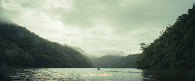 a boat traveling down a river surrounded by mountains