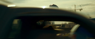 a rear view mirror of a car with a person in it