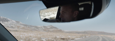 a man driving a car on a snowy road