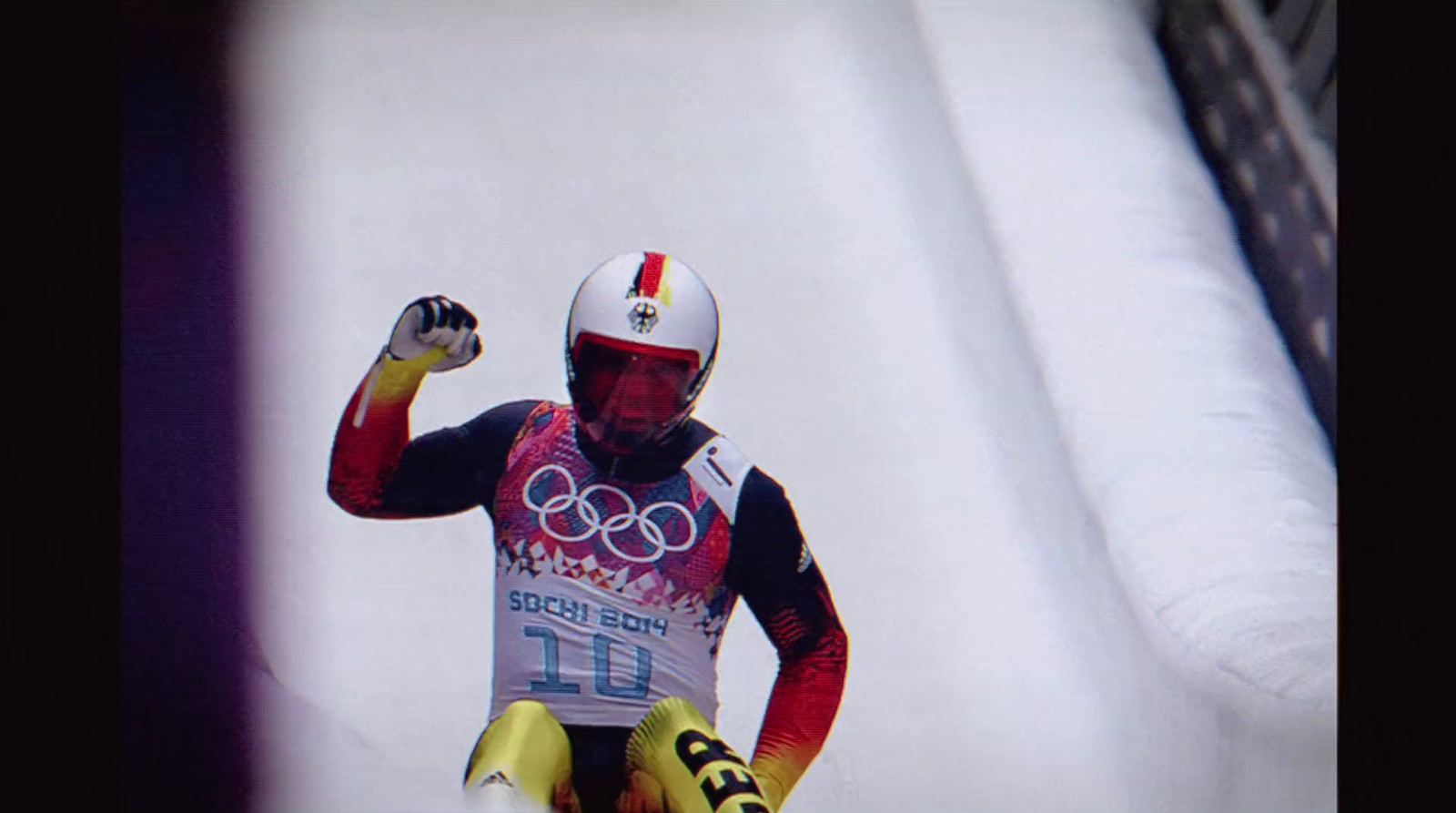 a man riding skis down a snow covered slope