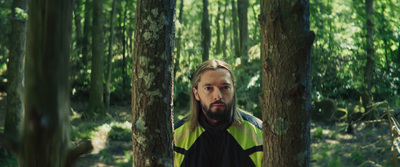 a man standing in the middle of a forest