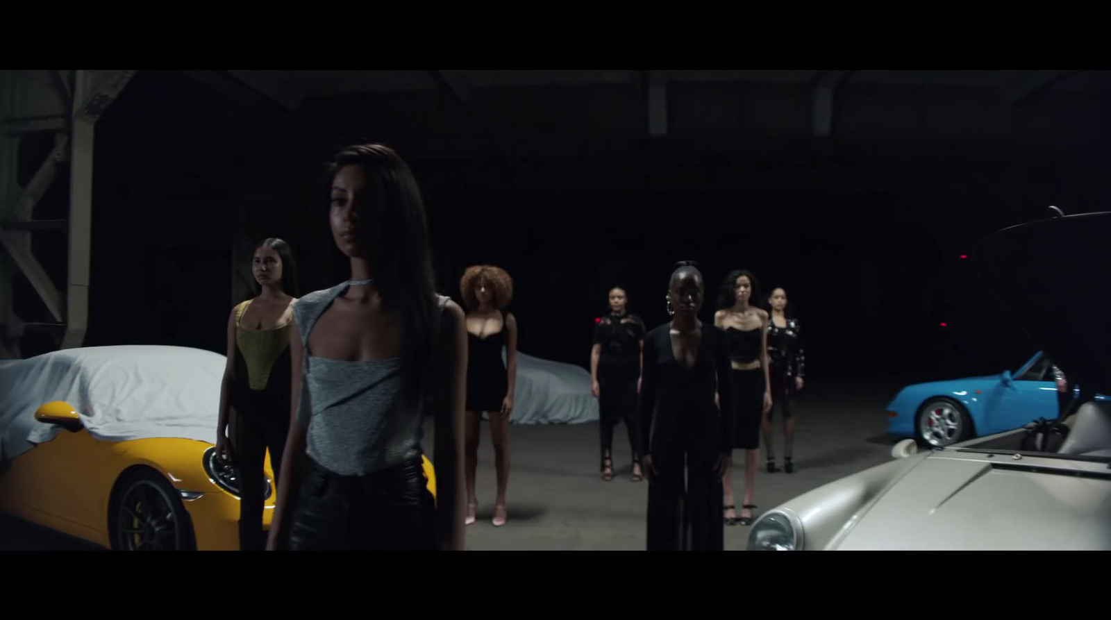 a group of women standing in front of a car