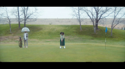 a couple of people standing on top of a green field