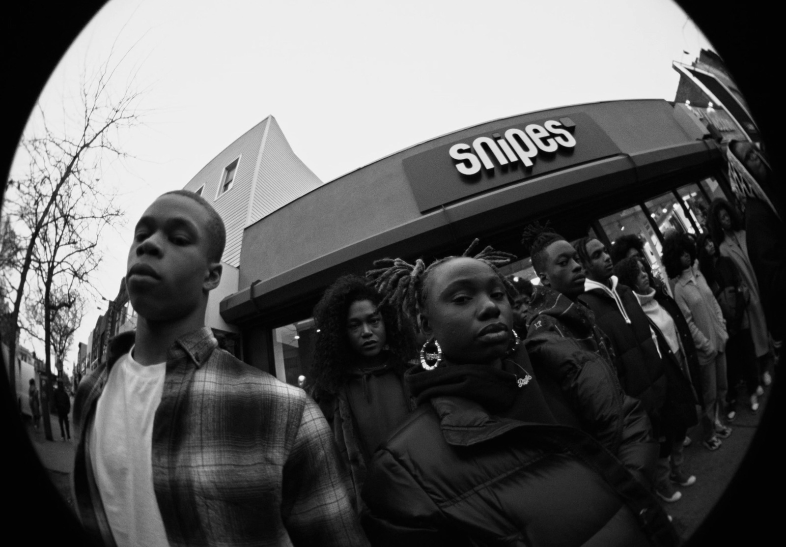 a group of people standing outside of a store