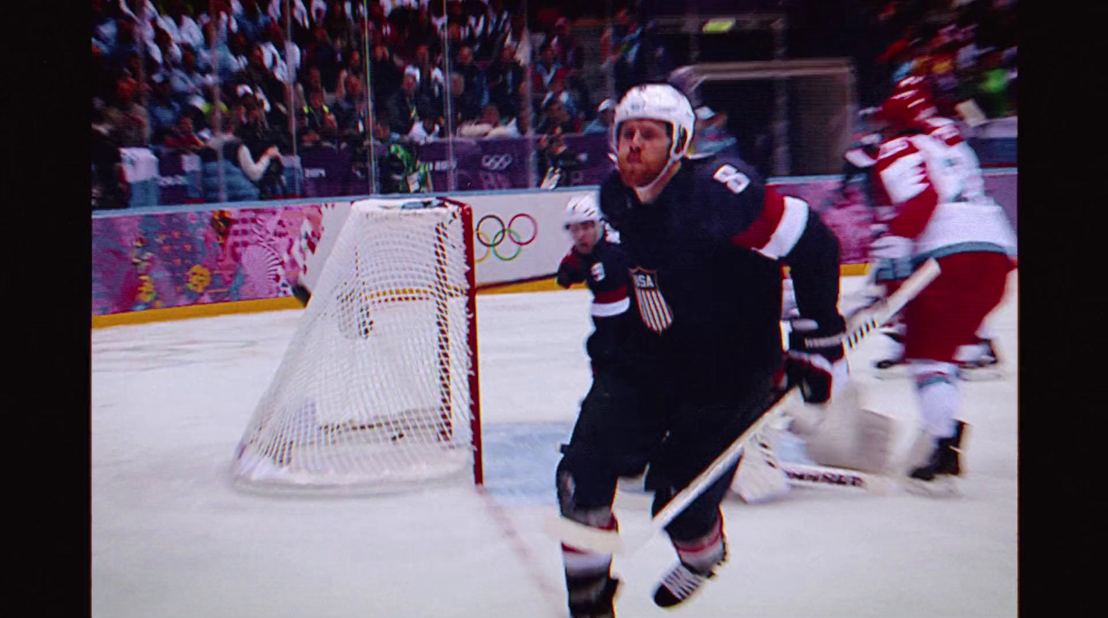 a hockey player on the ice with a stick in his hand