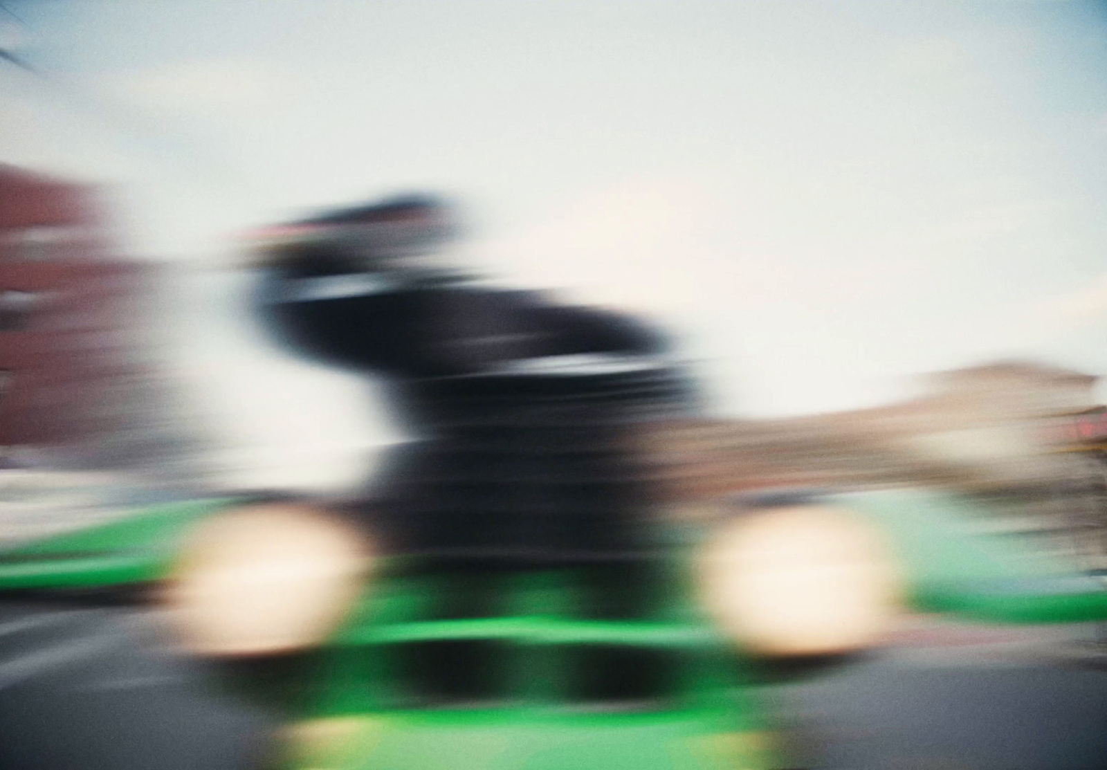 a blurry photo of a person riding a toy car