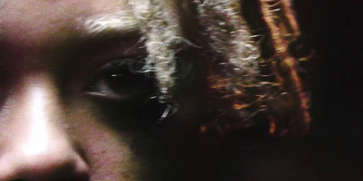 a close up of a person's face with a blurry background