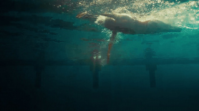 a person swimming under water in a pool