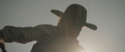 a blurry image of a person wearing a hat