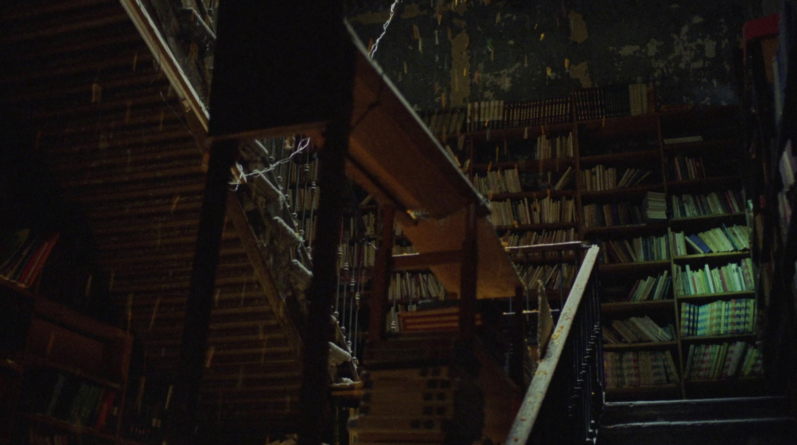 a staircase leading up to a bookshelf filled with books