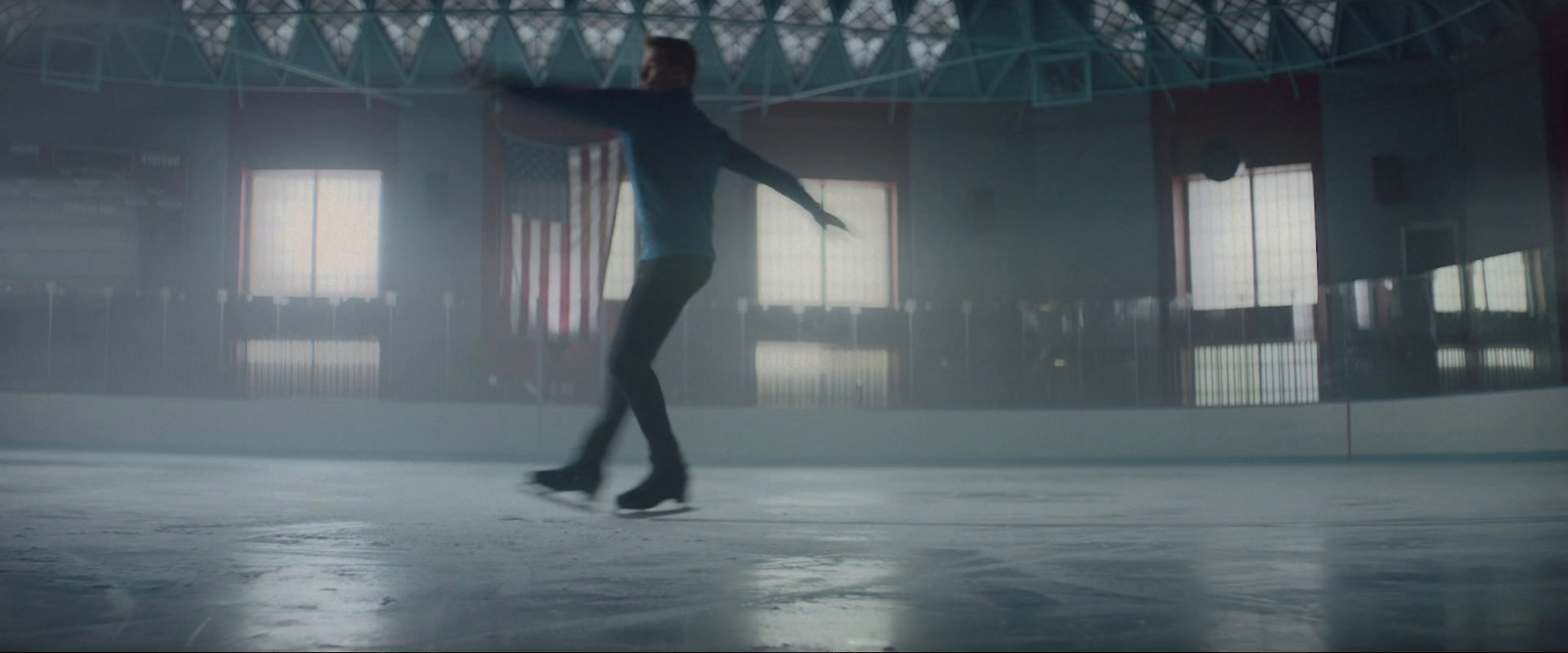 a woman is skateboarding in a large building