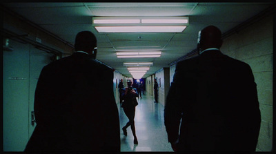 a group of people walking down a long hallway