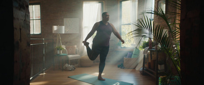 a man standing on a yoga mat in a living room