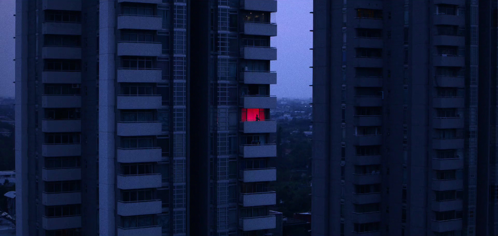 a tall building with a red light in the middle of it