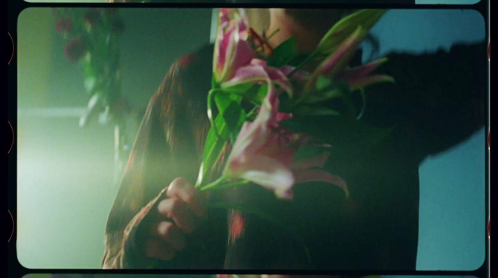 a woman holding a bunch of flowers in her hands