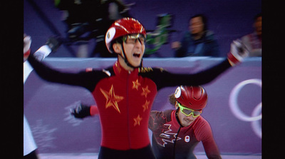 a couple of men riding on top of a skateboard