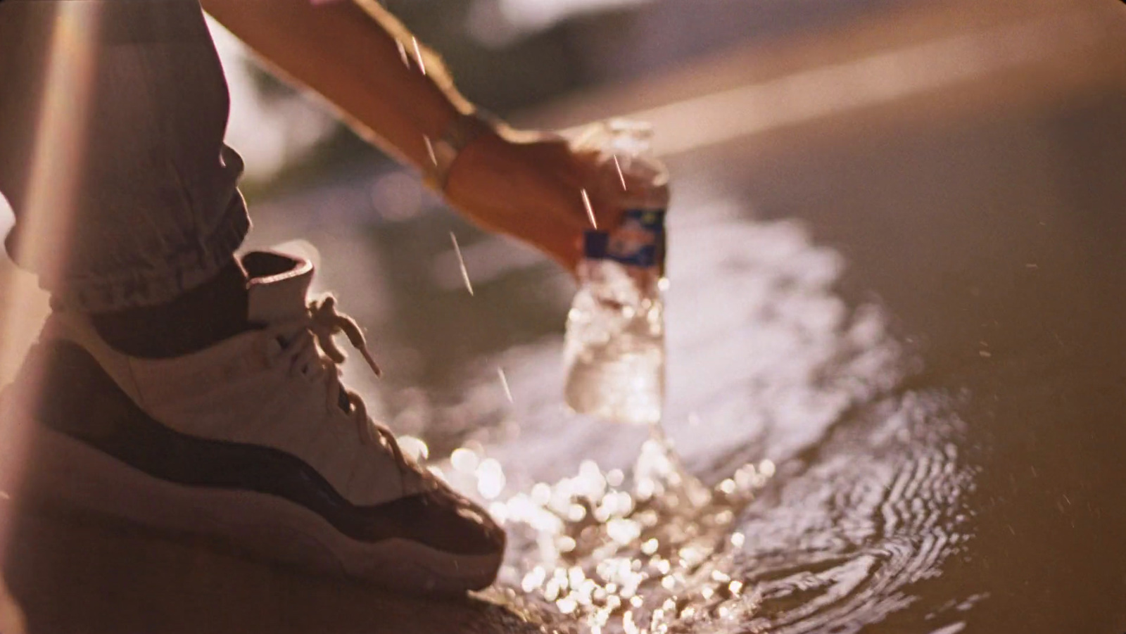 a person standing in water with their foot in the water