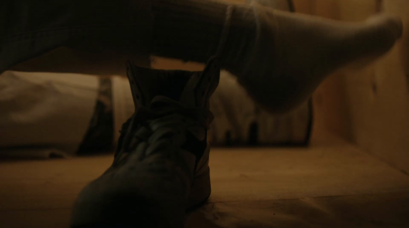 a person's feet with a shoe on the floor