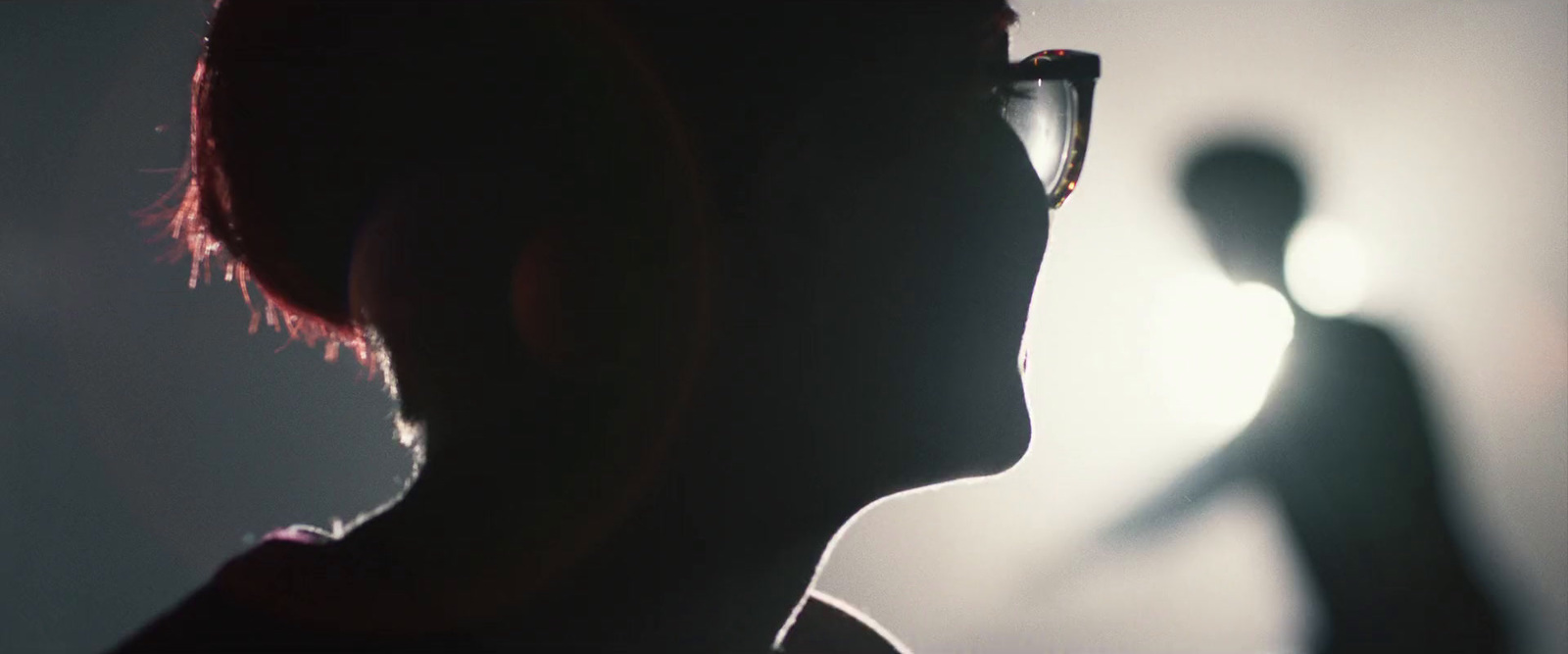 a silhouette of a person with a pair of glasses