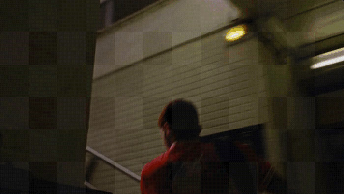 a woman in a red jacket is walking down a set of stairs