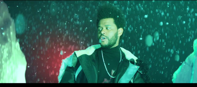 a man standing in the snow wearing a jacket