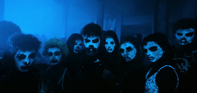 a group of people with their faces painted blue