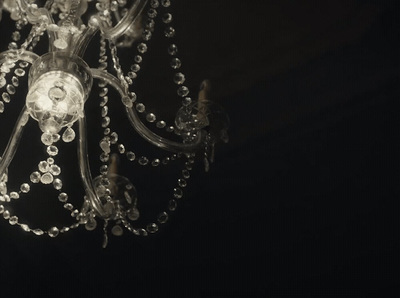 a chandelier hanging from a ceiling in a dark room